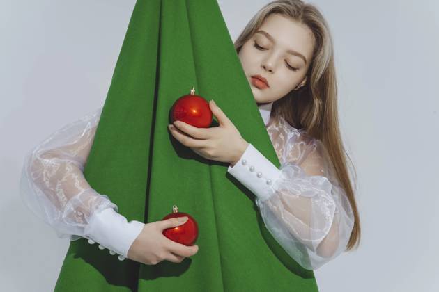 Girl holding red baubles embracing abstract Christmas tree against white background model released, Symbolfoto, IEF00221