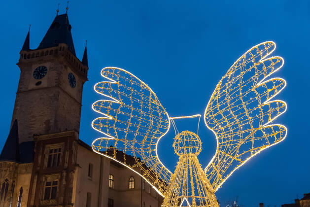 November 28, 2022, Prague, Czech Republic: Illuminated Angel decoration and tower of Old town hall as seen on the traditional Christmas market at Old town Square in Prague. Prague Czech Republic - ZUMAs197 20221128_zaa_s197_276 Copyright: xTomasxTkacikx