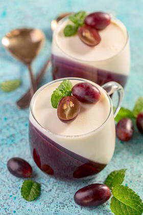 Panna cotta is a traditional Italian dessert. Traditional Italian dessert vanilla and berry Panna cotta served in glass cups on a wooden serving board, selective focus. Copyright: xZoonar.com MarinaxSaprunovax 16059003