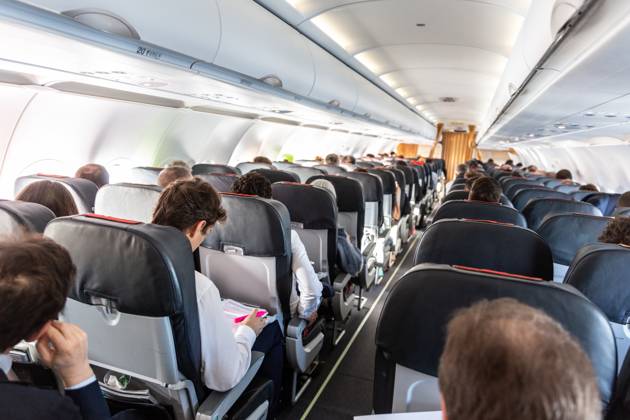 Interior of commercial airplane with passengers on their seats during flight. Interior of commercial airplane with unrecognizable passengers on their seats during flight. Copyright: xZoonar.com MatejxKastelicx 12437077