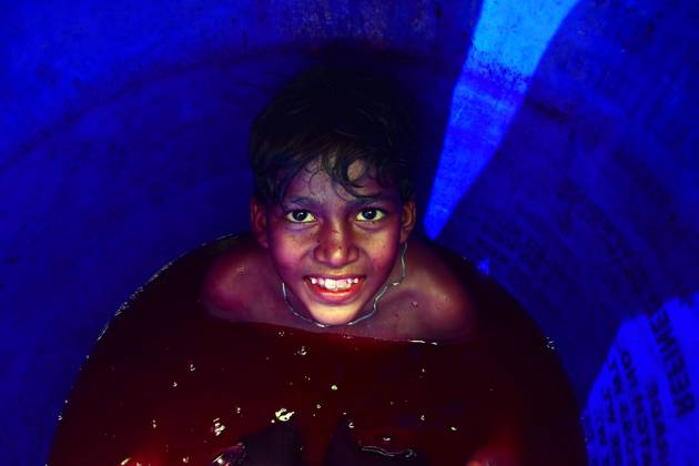 March 8, 2023, Prayagraj, Uttar Pradesh, India: Prayagraj: A child sit in a drum filled with coloured water during Holi festival Celebration in Prayagraj on Wednesday, March 08, 2023. Prayagraj India - ZUMAv115 20230308_zap_v115_013 Copyright: xPrabhatxKumarxVermax
