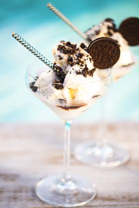 Vanilla sundae ice cream with chocolate sauce and cookies Vanilla ice cream with chocolate sauce and cookies by the pool Copyright: xZoonar.com DashaxPetrenkox 10799001