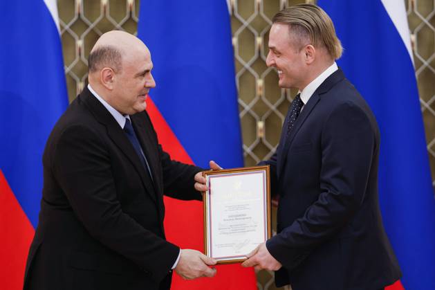 RUSSIA, MOSCOW - MARCH 24, 2023: Russia s Prime Minister Mikhail Mishustin (L) greets Askold Zapashny, Artistic Director of the Great Moscow State Circus, the author of the Istoriya History production, during a ceremony at the House of the Government to present national awards in the field of culture for 2022. Dmitry Astakhov POOL TASS  58044663