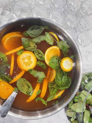 Punch large bowl with oranges and mint. Boiled citrus juice. Drink with a variety of fruits close up. Orange alcoholic cocktail. Empty glasses on the background table. Punch large bowl with oranges and mint. Boiled citrus juice. Drink with a variety of fruits close up. Orange alcoholic cocktail. Empty glasses on the background table. Lifestyle and party concept. Copyright: xZoonar.com DashaxPetrenkox 19832560