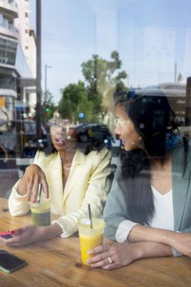 Friends talking to each other sitting in cafe seen through window model released, Symbolfoto property released, MMPF00703