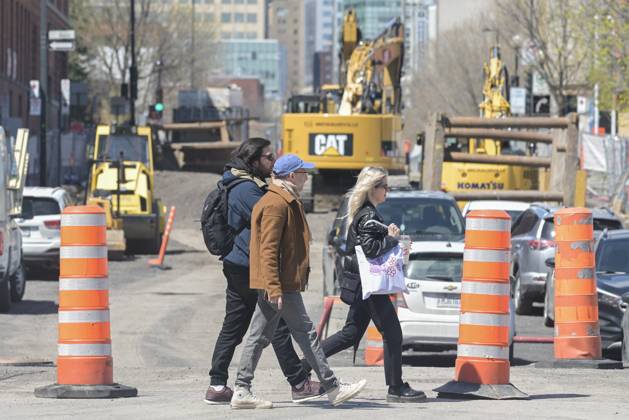 April 25, 2023, Montreal, PQ, Canada: People walk by construction cones in Montreal, Tuesday, April 25, 2023. The Quebec government has vowed to remove the cones after 72 hours of inactivity. Montreal Canada - ZUMAc35_ 20230425_zaf_c35_052 Copyright: xGrahamxHughesx