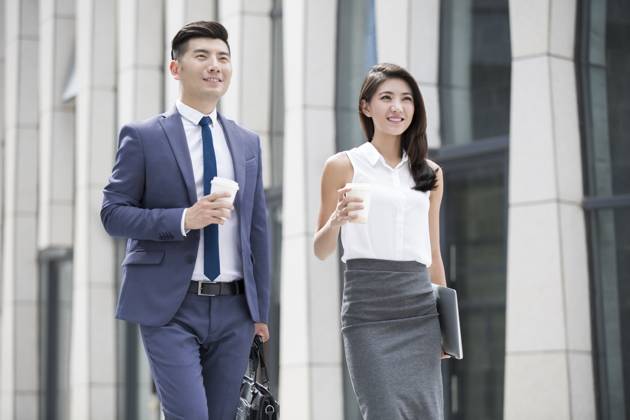 Confident Chinese business people walking outdoors Beijing China Copyright: xLianxFeix bji04970187