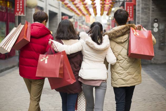 Happy young Chinese friends shopping for Chinese New Year Beijing China Copyright: xLianxFeix bji05210177