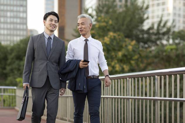 Confident Chinese business people walking outdoors Beijing China Copyright: xLanexOateyx bji06780151