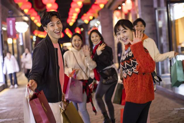 Happy young Chinese friends shopping for Chinese New Year Beijing China Copyright: xLanexOateyx bji06860077
