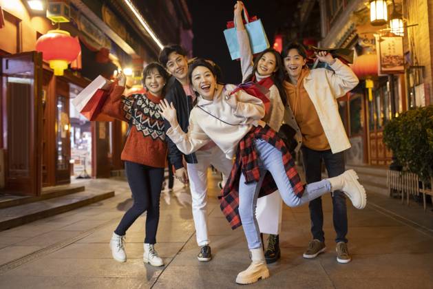Happy young Chinese friends shopping for Chinese New Year Beijing China Copyright: xLanexOateyx bji06860098