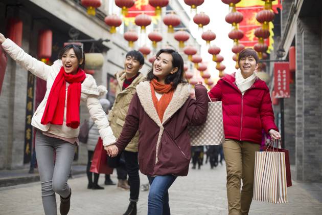 Happy young Chinese friends shopping for Chinese New Year Beijing China Copyright: xLianxFeix bji05210164