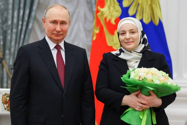 RUSSIA, MOSCOW - MAY 23, 2023: Russia s President Vladimir Putin awards the Mother Heroine title to large family mother Medni Kadyrova during a ceremony to present state decorations at the Moscow Kremlin. Vyacheslav Prokofyev TASS  59317541