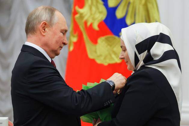 RUSSIA, MOSCOW - MAY 23, 2023: Russia s President Vladimir Putin awards the Mother Heroine title to large family mother Medni Kadyrova during a ceremony to present state decorations at the Moscow Kremlin. Vyacheslav Prokofyev TASS  59317702