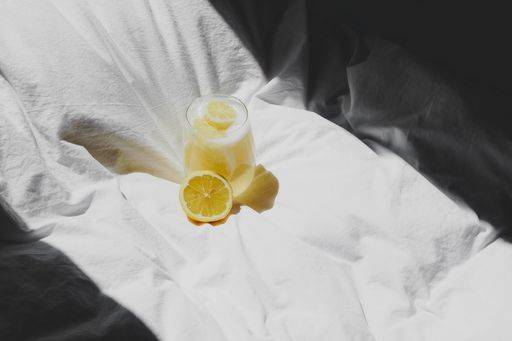 A closeup of a lemon juice with lemons on the bed *** einer closeupe des einer Zitrone Saft mit Zitronen am der Bett 4983758 RECORD DATE NOT STATED
