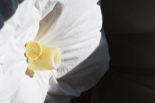 A closeup of a lemon juice with lemons on the bed *** einer closeupe des einer Zitrone Saft mit Zitronen am der Bett 4983788 RECORD DATE NOT STATED