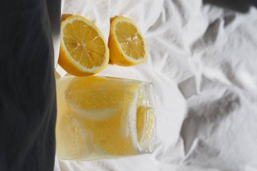 A closeup of a lemon juice with lemons on the bed *** einer closeupe des einer Zitrone Saft mit Zitronen am der Bett 4983824 RECORD DATE NOT STATED