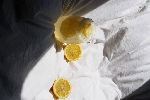 A closeup of a lemon juice with lemons on the bed *** einer closeupe des einer Zitrone Saft mit Zitronen am der Bett 4983828 RECORD DATE NOT STATED