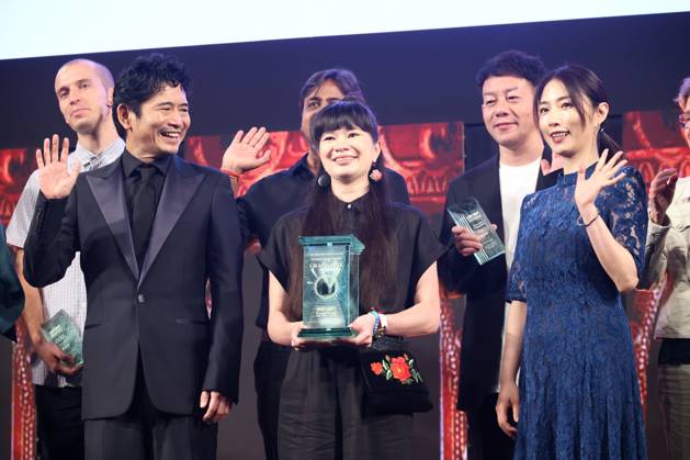 June 26, 2023, Tokyo, Japan - Poland based Japanese animation artist Izumi Yoshida (C) holds the trophy of the George Lucas award at the awarding ceremony of the Short Shorts Film Festival & Asia 2023 in Tokyo on Monday, June 26, 2023, actor Masato Hagiwara (L) and actress Megumi (R) smile. Yoshida won the George Lucas award, grand prix of the film festival for her short animation movie The Bridge . (photo by Yoshio Tsunoda AFLO)  , aflo_222753582.jpg,