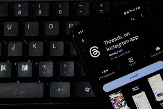 July 7, 2023, Bandung, West Java, Indonesia: In this photo illustration, Threads logo seen displayed on a smartphone and a keyboard in the background. Threads is the new social network from Meta Platforms which was launched on the 5th of July 2023. According to Meta CEO Mark Zuckerberg, the Threads app is designed to rival Twitter. As of 6th of July 2023, the Thread app already has 10 million users. Bandung Indonesia - ZUMAs281 20230707_zip_s281_005 Copyright: xAlgixFebrixSugitax
