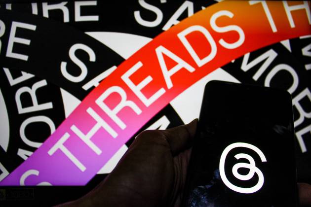 July 7, 2023, Bandung, West Java, Indonesia: In this photo illustration, Threads logo seen displayed on a smartphone and a threads logo in the background. Threads is the new social network from Meta Platforms which was launched on the 5th of July 2023. According to Meta CEO Mark Zuckerberg, the Threads app is designed to rival Twitter. As of 6th of July 2023, the Thread app already has 10 million users. Bandung Indonesia - ZUMAs281 20230707_zip_s281_013 Copyright: xAlgixFebrixSugitax