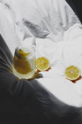 A closeup of a lemon juice with lemons on the bed *** einer closeupe des einer Zitrone Saft mit Zitronen am der Bett 4983764 RECORD DATE NOT STATED