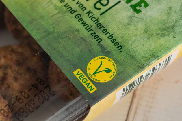 Das V Label (European Vegetarian Union) auf einer Packung veganer Falafel. Kennzeichnung für Vegane Lebensmittel