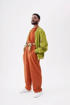 Young man with hands in pockets standing against white background model released, Symbolfoto, EKHF00067