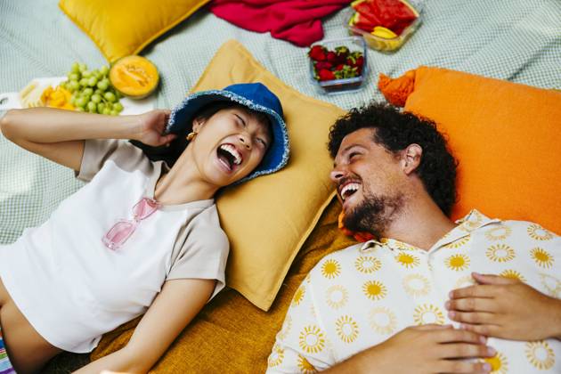Happy friends enjoying together and lying on picnic blanket model released, Symbolfoto, EBSF03762