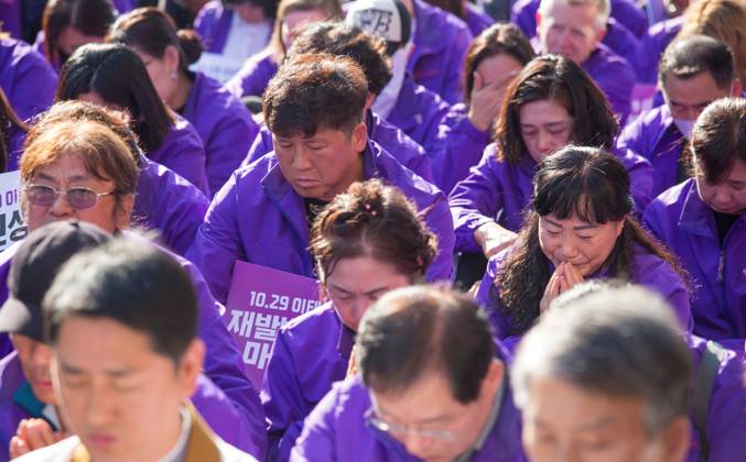 Itaewon tragedy, Oct 29, 2023 : Family members of victims of the Itaewon crowd crush participate in a memorial event in front of an alleyway, the site of the crowd crush during Halloween celebrations last year, in Seoul, South Korea. Thousands of people and family members of the victims gathered in central Seoul on Sunday to cherish the memories of the deceased at a memorial event marking the first anniversary of the deadly Itaewon crowd crush that claimed 159 lives. They demanded a probe into the disaster and punishment of officials found responsible for the tragedy.  , aflo_234059760.jpg,