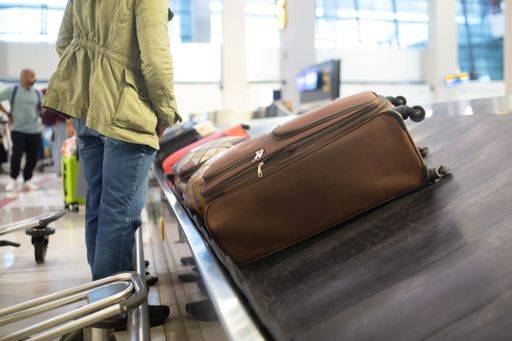 The luggage belt with suitcases being delivered to the passengers at the arrival terminal 22226014 RECORD DATE NOT STATED