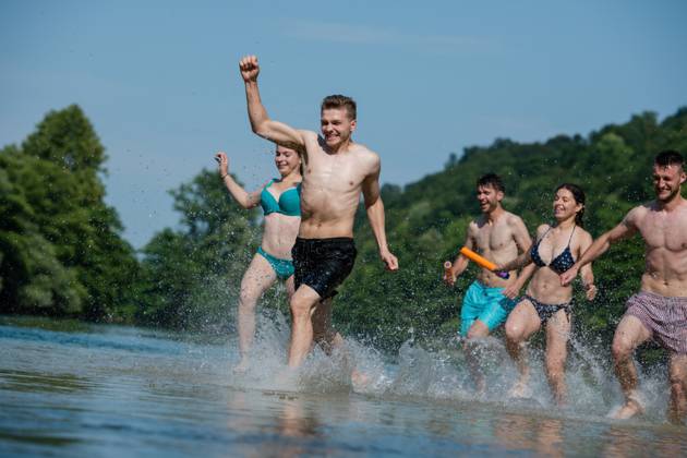 summer joy friends having fun on river summer joy group of happy friends having fun while running and splashing on river ,model released, Symbolfoto Copyright: xZoonar.com benisxarapovicx 14149431 ,model released, Symbolfoto ,property released