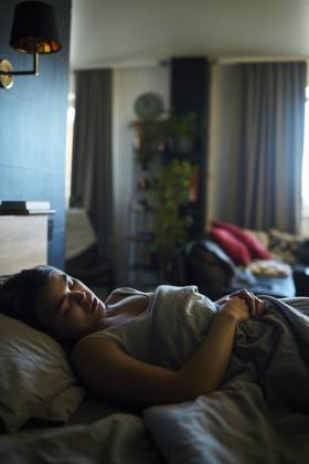 Woman sleeping on bed at home model released, Symbolfoto property released, DSHF01115