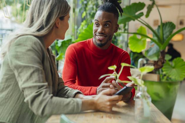 Smiling businessman planning strategy with colleague sitting at cafe model released, Symbolfoto property released, JOSEF22150
