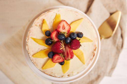 An overhead shot of delicious mango strawberry summer naked cake on a white table with white background 607004 RECORD DATE NOT STATED