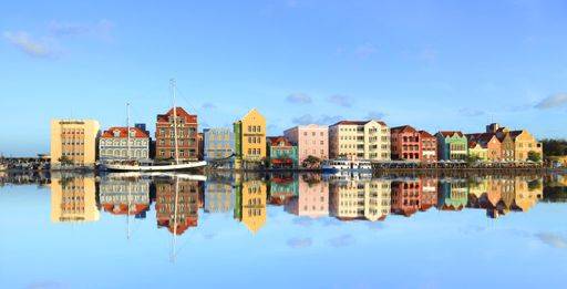 A beautiful shot of colorful building in the city with reflection on water 1955932