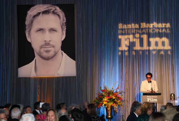 January 13, 2024, Santa Barbara, California, U.S.A: Executive Director of SBIFF Roger Durling welcomes guests and talks about the man of honor Ryan Gosling as his photo stares out from the curtain behind him, during the Kirk Douglas Award for Excellence in Film fundraising gala for the Santa Barbara International Film Festival 2024, on January 13. The exclusive dinner event (where Gosling and Barbie Director Greta Gerwig spoke later) was held at the Ritz-Carlton Hotel, Santa Barbara. Santa Barbara U.S.A - ZUMAk144 20240113_znp_k144_069 Copyright: xAmyxKatzx