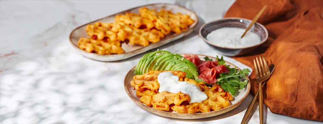 Hearty sweet potato or pumpkin waffles with avocado, salmon, arugula and sauce Hearty sweet potato or pumpkin waffles with avocado, salmon, arugula and sauce Copyright: xZoonar.com BurakovaxIrinax 21030474