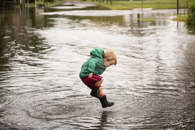 Caucasian boy jumping in puddle Norfolk, Virginia, USA, 02.10.2015, model released, TTBB_BLD188006.jpg, 2-3 years, active, alone, authentic, authenticity, blonde hair, blurred motion, boy, boys, candid, casual clothing, caucasian, childhood, color image, day, decisive moment, disaster, flooding, full length, happy, horizontal, jumping, looking down, motion, nature, norfolk, one person, outdoors, people, photography, playing, preschooler, puddle, real people, recreation, resilience, rising, rubber boot, sea level, side view, storm, united states, virginia, wellingtons, real lifeaccessory, action, adversity, america, american, americas, amusement, apparel, ascending, blond, blurry, calamity, catastrophe, cheerful, child, children, clothes, c Copyright: xRobertoxWestbrookx