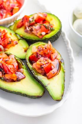 Avocados filled with bruschetta and balsamic vinaigrette - vegan appetizers Avocados filled with bruschetta and balsamic vinaigrette - vegan appetizers Copyright: xZoonar.com IngridxBalabanovax 21106603