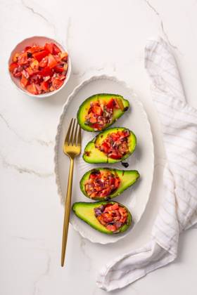 Avocados filled with bruschetta and balsamic vinaigrette - vegan appetizers Avocados filled with bruschetta and balsamic vinaigrette - vegan appetizers Copyright: xZoonar.com IngridxBalabanovax 21106614