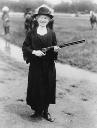 Annie Oakley with the gun Buffalo Bill gave her, 1922 (b w photo) 3247842 Annie Oakley with the gun Buffalo Bill gave her, 1922 (b w photo) by American Photographer, (20th century); Private Collection; (add.info.: Annie Oakley (1860-1926) born Phoebe Ann Moses, worked as sharpshooter in vaudeville, circuses, and Wild West shows, joining Buffalo Bill™s Wild West in 1885. William Frederick Buffalo Bill Cody (1846-1917) American soldier and showman gave her this Winchester 1873 .44-40 caliber factory-made, smooth bore rifle made in 1892. They both used smooth-bore rifles in the Wild West Show for shooting at aerial targets.). Copyright: xBridgemanxImagesx 3247842