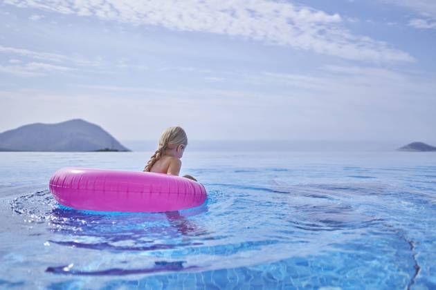 Girl swimming with inflatable tube in blue pool model released, Symbolfoto property released, ANNF00810
