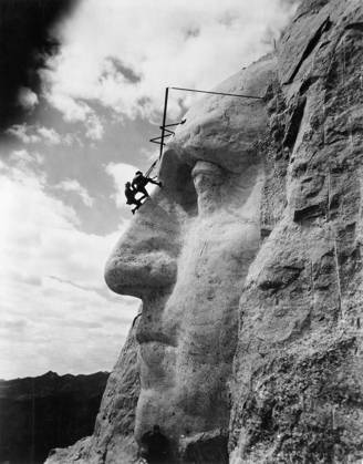 MOUNT RUSHMORE, c1932. American sculptor John Gutzon de la Monthe Borglum (1867-1941), inspecting work on the face of George Washington on Mount Rushmore in South Dakota. Photograph, c1932.  Copyright: xGRANGERx xGRANGERx 0640834