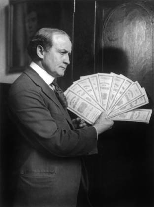 HARRY HOUDINI (1874-1926). American magician. Houdini holding $10,000 of New York City Bonds at City Hall in Boston as a guarantee that he could detect and repeat any phenomena shown by the famous psychic medium Margery Crandon. Photograph, 1924.  Copyright: xGRANGERx xGRANGERx 0651396