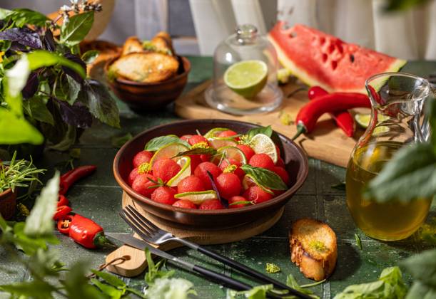 Spicy salad of fresh watermelon balls with basil, lime, rosemary and fennel, topping with olive oil Spicy salad of fresh watermelon balls with basil, lime, rosemary and fennel, topping with olive oil on dark green table surface with sunny light Copyright: xZoonar.com VictoriaxKondysenkox(ArtSvitlyna)x 20788153