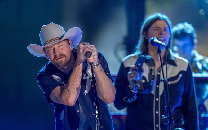 April 5, 2024, Austin, Tx, United States: American country rock band NEEDTOBREATHE with lead singer BEAR RINEHART performs at a taping of CMT Country Crossroads in front of the University of Texas Tower on April 5, 2024. At right is bassist SETH BOLT Austin United States - ZUMAd150 20240405_znp_d150_020 Copyright: xBobxDaemmrichx