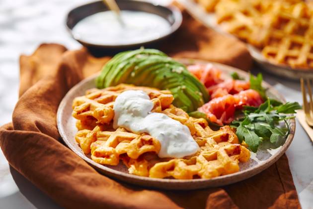 Hearty sweet potato or pumpkin waffles with avocado, salmon, arugula and sauce Hearty sweet potato or pumpkin waffles with avocado, salmon, arugula and sauce Copyright: xZoonar.com BurakovaxIrinax 21206814
