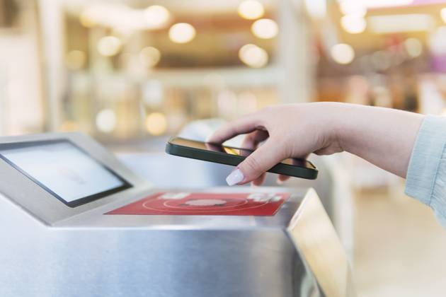 Hand of woman scanning QR code through smart phone at turnstile model released, Symbolfoto, PNAF06180