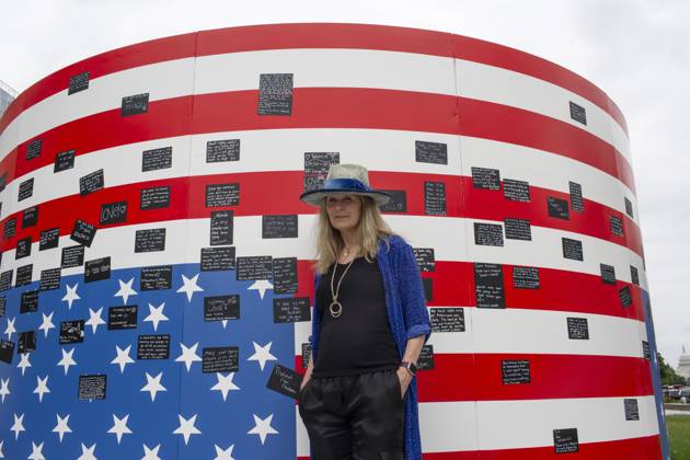 May 19, 2024, Washington, District Of Columbia, USA: Acclaimed visual artist Suzanne Brennan Firstenberg poses for a photograph with her art installation alienable right to life, at Freedom Plaza in Washington, D.C. The installation features a massive American flag created from the names of 1,039 mass shooting victims overlaying an image of the Declaration of Independence. Additional elements are an original poem addressing all victims of gun violence, and a circular mural for visitors to share personal stories. Washington USA - ZUMAr125 20240519_fap_r125_003 Copyright: xProbalxRashidx